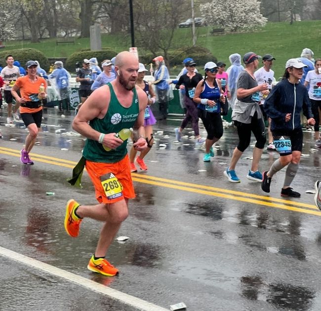 Colin Carey running in the Boston Marathon with Team TCF