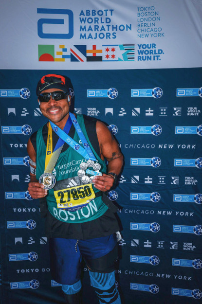 Marcel Thompkins running in the Boston Marathon with Team TCF